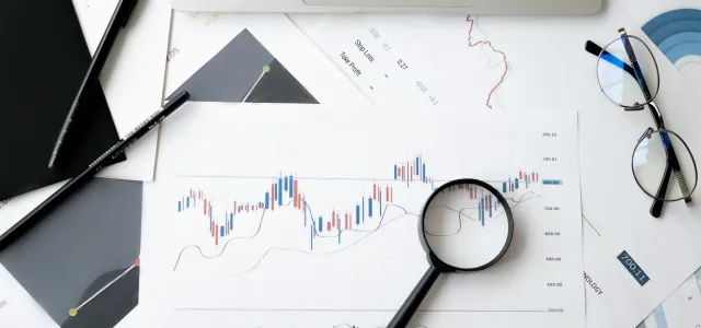 magnifying glass on top of a financial chart