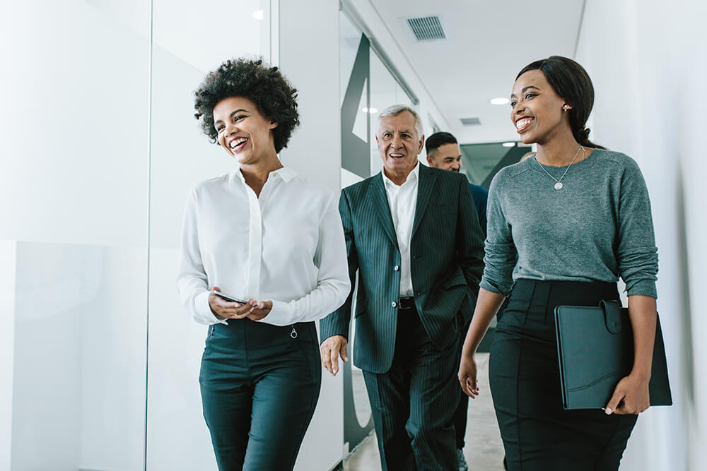 Team of corporate professionals in office corridor